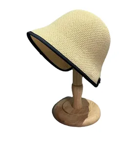 Minimalist beige woven sun hat with black trim and wide brim for summer beach protection