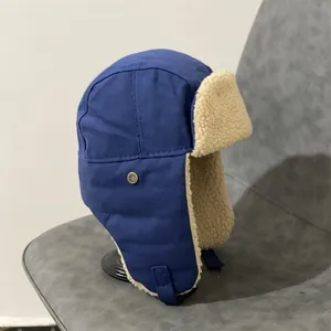 Detail of the thick sherpa fleece lining and windproof canvas of the blue aviator hat