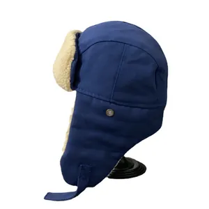 Navy blue trapper hat with beige sherpa lining and ear flaps for winter windproof protection