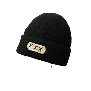 Women's warm black mohair knit beanie with trendy white patch and black embroidery detail