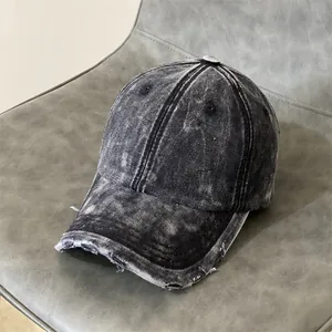 Detailed macro view of distressed denim texture and frayed brim on vintage baseball cap