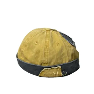 Berretto docker vintage in denim giallo senape e grigio con patch ed effetto usurato