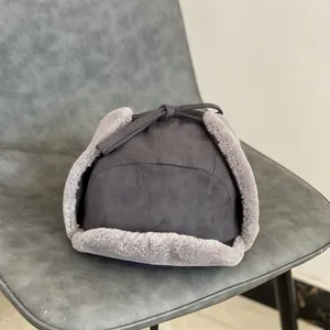 Close-up of suede trapper hat with thick faux lambswool lining and adjustable drawstring