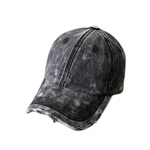 Distressed washed denim baseball cap in charcoal black with frayed brim and vintage finish
