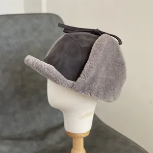 Detail of dark grey suede trapper hat with soft faux fur lining on a white mannequin head