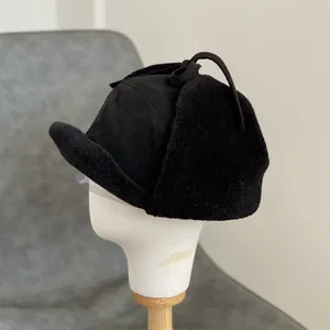 Close-up of black suede winter trapper hat with thick plush lining and ear flaps