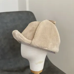 Detail of beige faux suede trapper hat with thick plush fleece lining and ear flaps