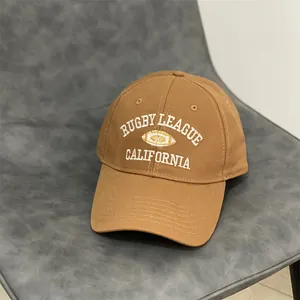 Brown cotton baseball cap with Rugby League California embroidery on a leather seat