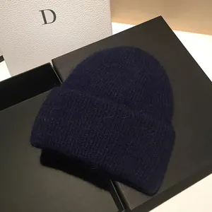 Dettaglio del berretto blu scuro in maglia a coste con morbida consistenza in pelo di coniglio