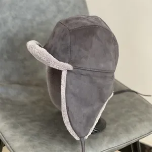Thick faux suede trapper hat with warm lamb wool lining and long ear flaps in dark grey