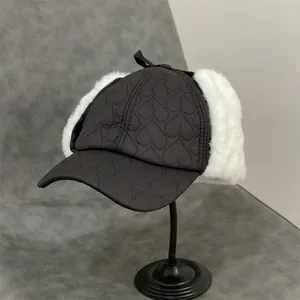 Detail of winter baseball hat featuring heart quilting and plush earflaps with a bow