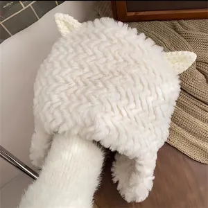 Detail of white plush trapper hat with cat ears and thick wavy woven texture