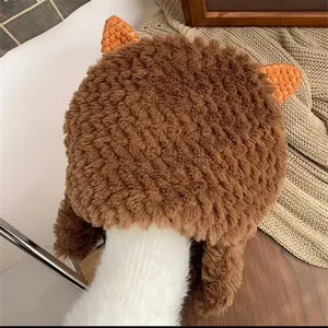 Cute brown plush earflap hat with orange bear ears for winter warmth and comfort
