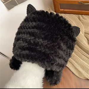 Close-up of black plush cat ear winter hat showing thick furry texture and cozy earflaps