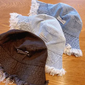 Frayed edge denim bucket hats in three washed colors with metal label detail