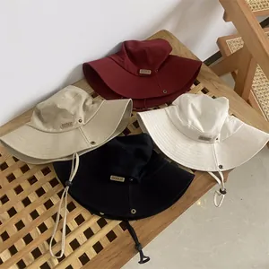 Minimalist wide brim bucket hats for women in four colors with adjustable drawstrings