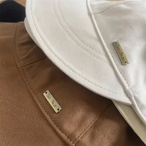 Close-up of wool fisherman hats with metallic logo tag and premium stitching details