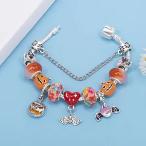 Halloween snake chain bracelet with pumpkin, skull, and purple bat wing charms