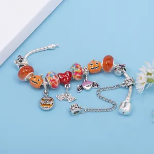 Halloween charm bracelet with pumpkin and skull beads on silver chain