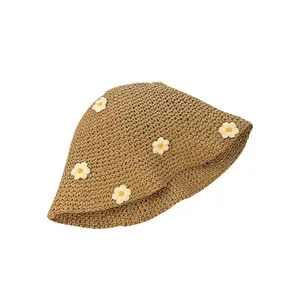 Light brown woven straw cloche hat featuring small white daisies for sun protection