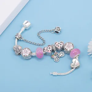 Bracciale con perline di cristallo rosa e ciondoli a cuore e bicicletta in argento