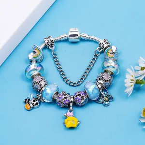 Charming silver bracelet featuring colorful bee, rainbow, butterfly and glass bead charms