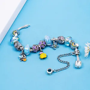 Cartoon charm bracelet with bee butterfly and rainbow pendants on blue glass beads