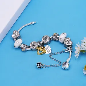 Bracelet chaîne serpent en argent avec breloques cœur strass et étoiles sur fond bleu