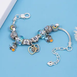DIY children's silver beaded bracelet with blue charms, rainbow, butterfly and bee pendants