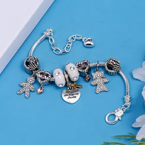 Romantic silver beaded bracelet with heart, boy, and girl charms on a blue background