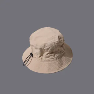 Close-up of quick-dry khaki bucket hat featuring adjustable black drawstring and reinforced brim