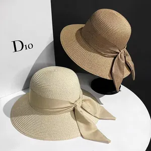 Detailed texture of woven straw sun hats with elegant bow ribbons in beige and brown