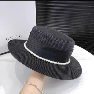 Elegant black straw sun hat with ribbon and pearls, flat top wide brim beach headwear