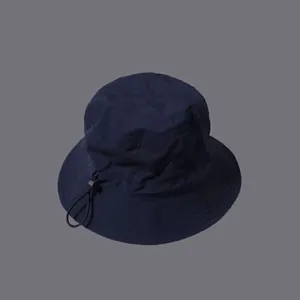 Detail of dark blue quick-dry sun hat with adjustable drawstring and plastic toggle