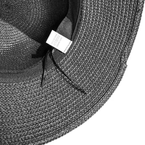 Close-up of the internal woven texture and 100% paper material label on the black sun hat