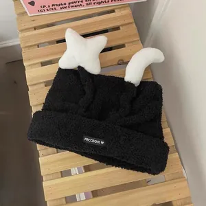 Plush black knit beanie for women with white star decorations and warm ear protection