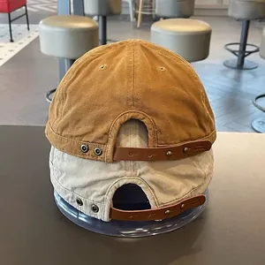 Retro canvas docker hats in yellow and off-white with adjustable leather back straps