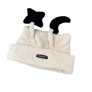 Cute off-white plush earflap beanie with star and moon charms and FRCCDOM woven label