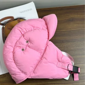 Glossy pink winter trapper hat with ear flaps and buckle strap for cold weather outdoors
