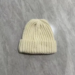 Thick cream knitted rabbit fur beanie with vertical ribs and wide fold-over cuff design