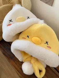 Detailed view of yellow and white plush duck hats with soft faux fur texture