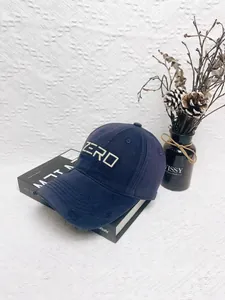 Close-up of distressed brim and ZERO embroidery on navy blue cotton baseball cap