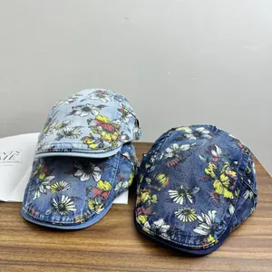 Vintage denim baseball cap with floral daisy pattern in light and dark blue wash