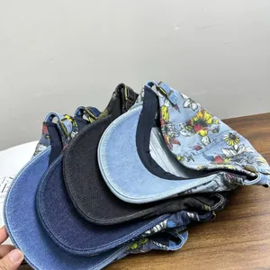 Detail view of denim baseball caps with adjustable metal buckles and flower embroidery