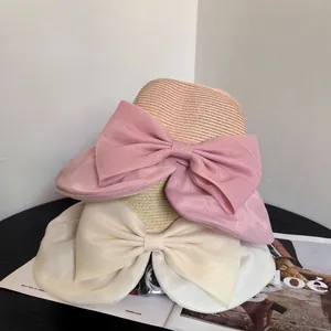 Women's wide brim organza bow sun hat in beige and pink for summer beach vacations