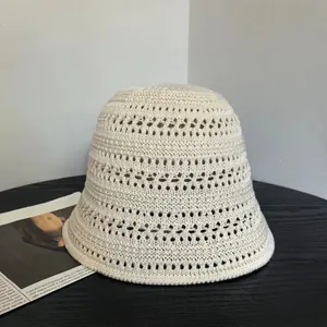 Chic beige crochet bucket hat for women featuring a minimalist knitted hollow pattern