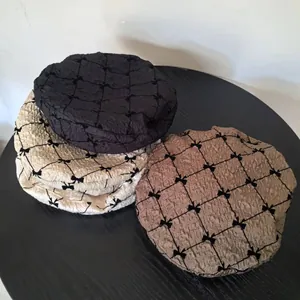 Close-up of seersucker berets with bow patterns in black, off-white, and coffee colors