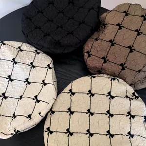 Detailed view of seersucker berets with black bow grid pattern in various colors