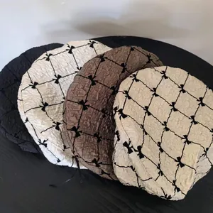 Detailed texture of seersucker berets with sweet bow pattern in four elegant colors