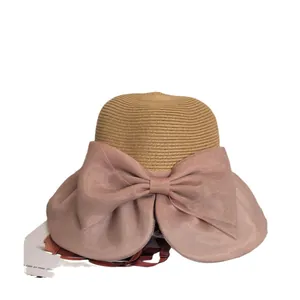 Summer beige straw hat for women featuring a large pink organza bow for sun protection